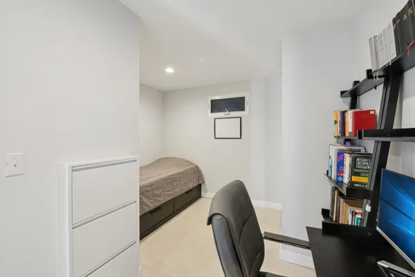 a bedroom with a bed and a desk