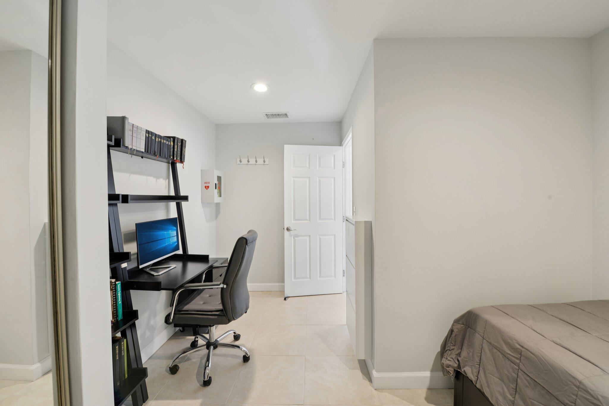 21024 Country Creek Drive Boca Raton, FL 33428 - Photo 24 of 59 a view of a workspace with furniture and a gate