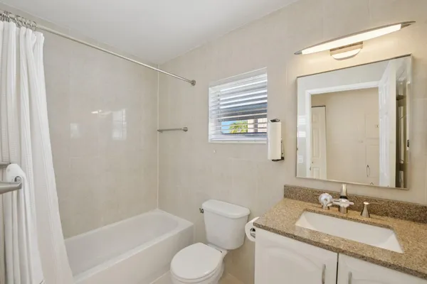 a view of a porch with furniture and garden