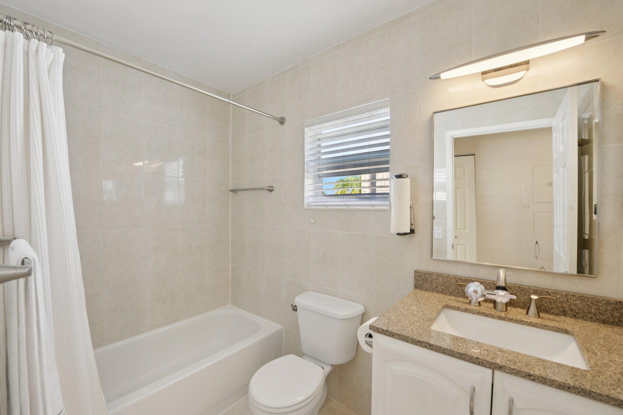 21024 Country Creek Drive Boca Raton, FL 33428 - Photo 28 of 59 a bathroom with a sink toilet and shower