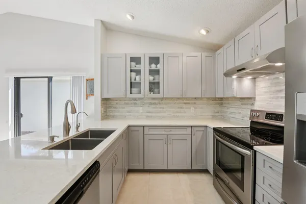 a kitchen with a sink cabinets and stainless steel appliances
