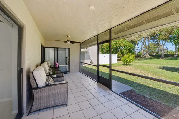 a view of a house with a yard and a tree