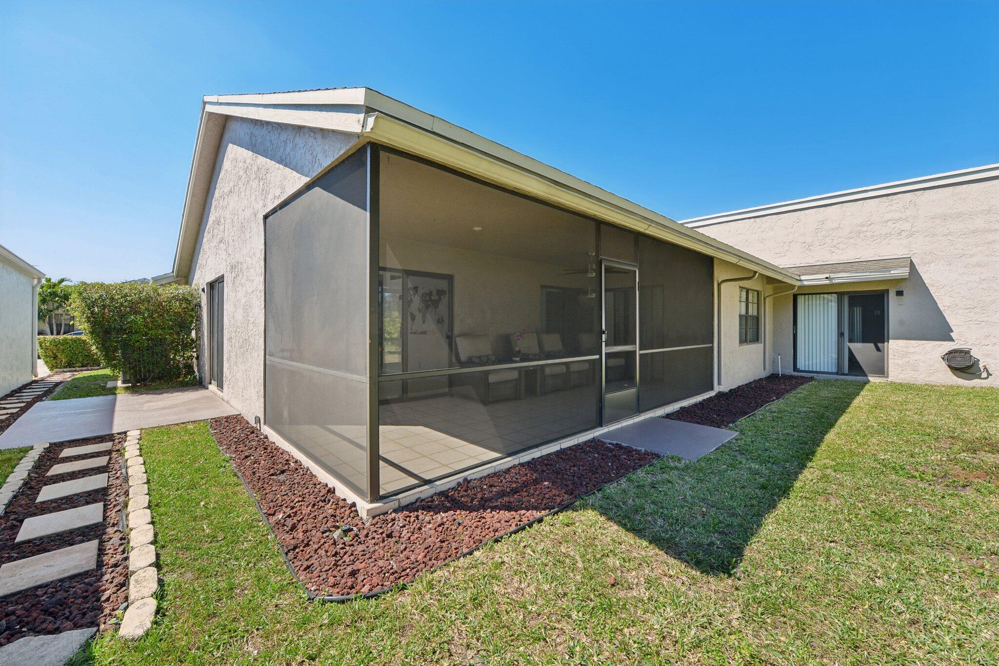 21024 Country Creek Drive Boca Raton, FL 33428 - Photo 35 of 59 a view of a backyard with a garden and entertaining space