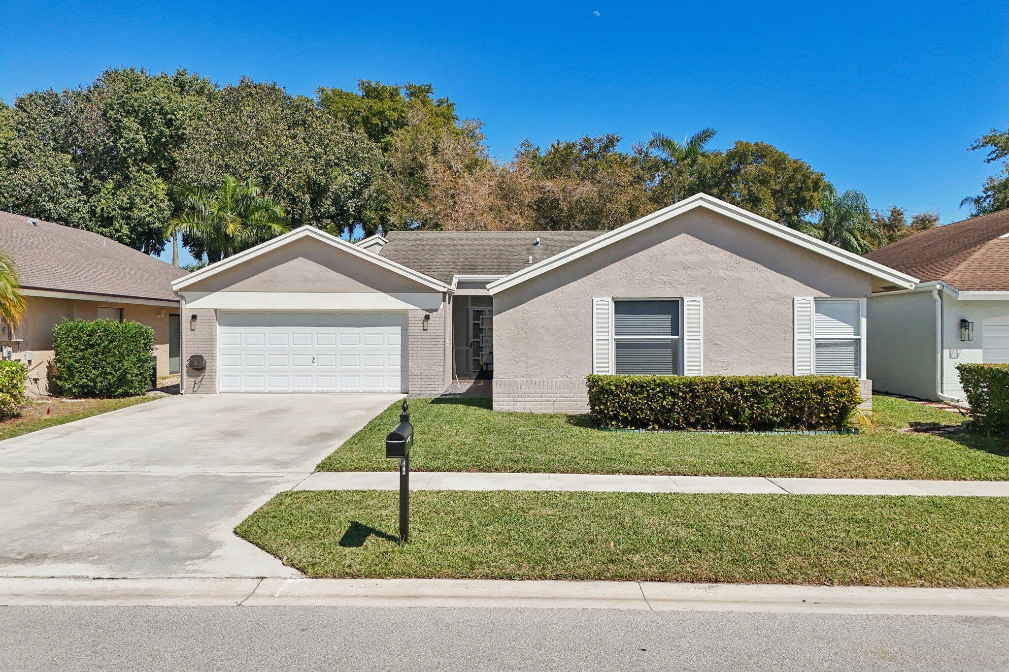 21024 Country Creek Drive Boca Raton, FL 33428 - Photo 40 of 59 a front view of a house with a yard