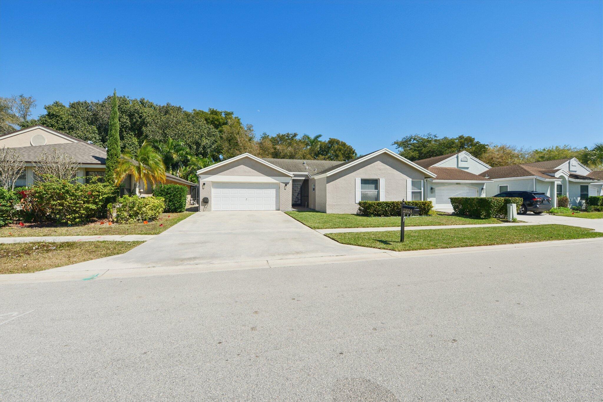 21024 Country Creek Drive Boca Raton, FL 33428 - Photo 41 of 59 a view of a house with a big yard and large trees
