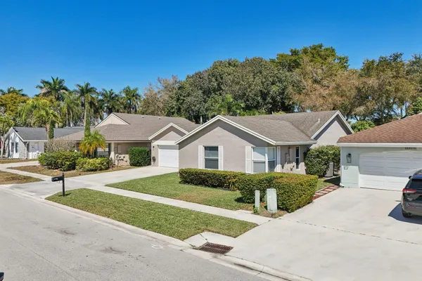 an aerial view of a houses with a yard