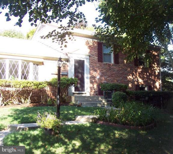 a backyard of a house with a garden and outdoor seating