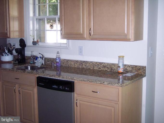 6209 Redwing Road Bethesda, MD 20817 - Photo 16 of 25 a kitchen with granite countertop white cabinets and a sink