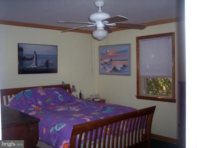 6209 Redwing Road Bethesda, MD 20817 - Photo 23 of 25 a bedroom with a bed and a chandelier