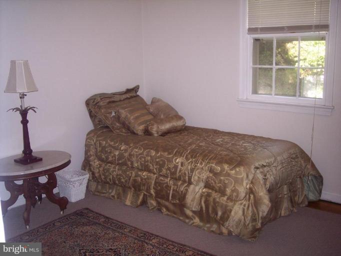 6209 Redwing Road Bethesda, MD 20817 - Photo 24 of 25 a bed sitting in a bedroom next to a window