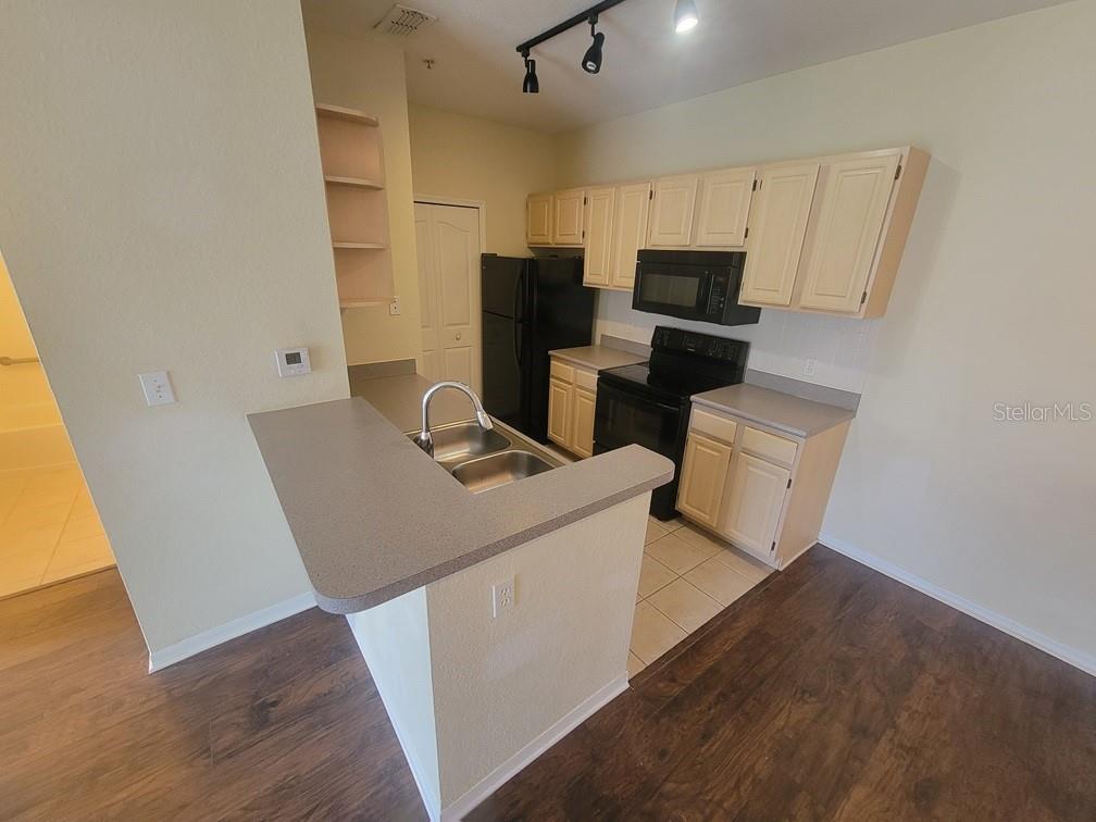 5709 Legacy Crescent Place, Unit 103 Riverview, FL 33578 - Photo 11 of 22 a living room with stainless steel appliances furniture cabinets and a wooden floor