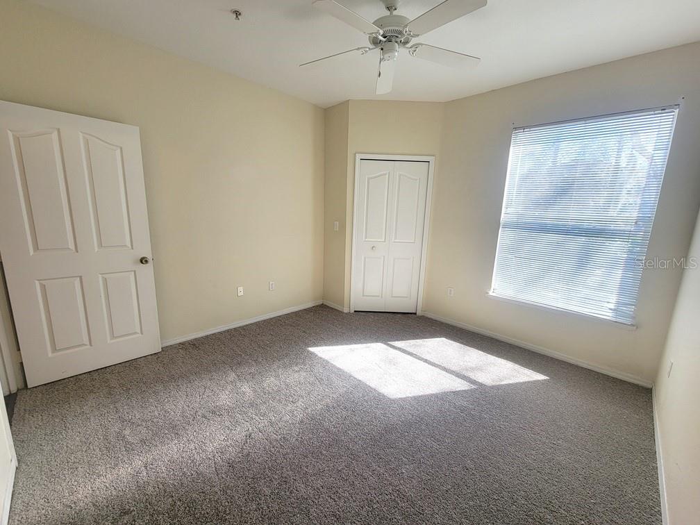 5709 Legacy Crescent Place, Unit 103 Riverview, FL 33578 - Photo 16 of 22 an empty room with windows and fan