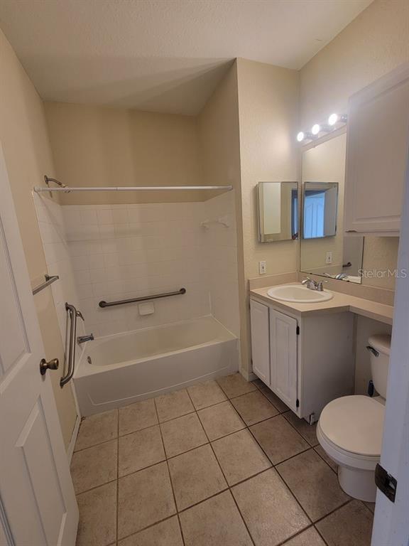 5709 Legacy Crescent Place, Unit 103 Riverview, FL 33578 - Photo 18 of 22 a bathroom with a sink a toilet and shower