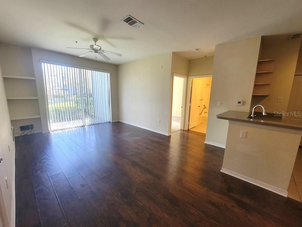5709 Legacy Crescent Place, Unit 103 Riverview, FL 33578 - Photo 4 of 22 wooden floor in an empty room with a window
