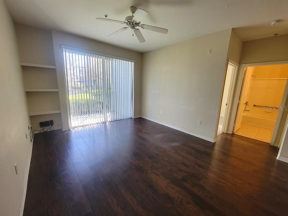 5709 Legacy Crescent Place, Unit 103 Riverview, FL 33578 - Photo 5 of 22 an empty room with wooden floor and windows