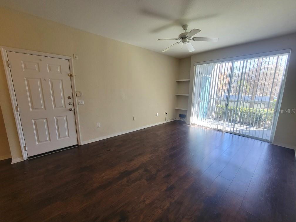 5709 Legacy Crescent Place, Unit 103 Riverview, FL 33578 - Photo 6 of 22 an empty room with wooden floor and windows