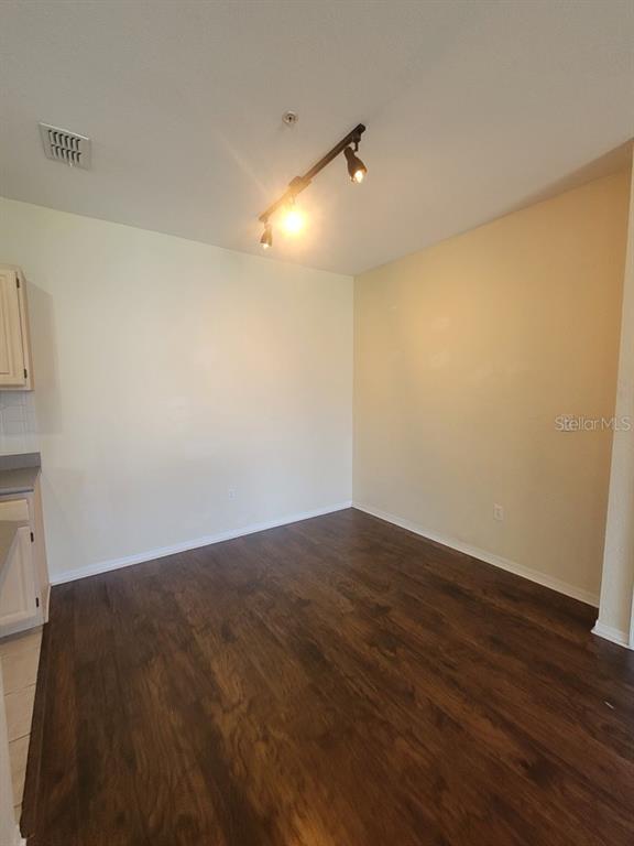5709 Legacy Crescent Place, Unit 103 Riverview, FL 33578 - Photo 9 of 22 an empty room with wooden floor and windows