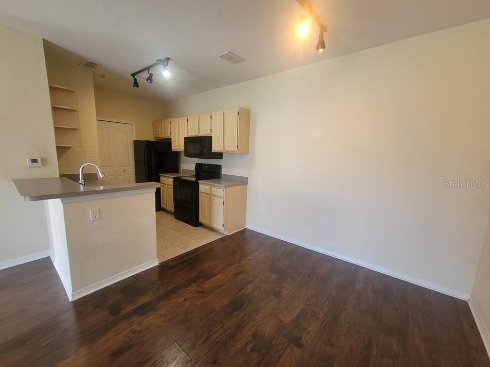 5709 Legacy Crescent Place, Unit 103 Riverview, FL 33578 - Photo 10 of 22 a kitchen with a sink cabinets and wooden floor
