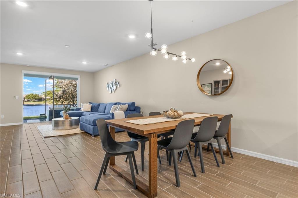 14644 Edgewater Circle Naples, FL 34114 - Photo 11 of 37 a view of a dining room with furniture window and wooden floor