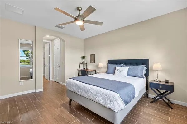 a bedroom with a bed and a chandelier