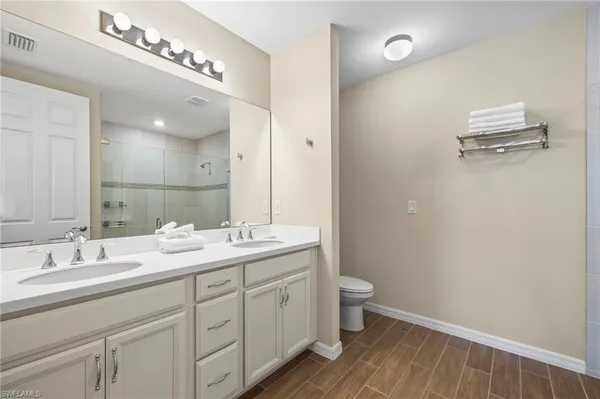 a bathroom with a double vanity sink and a mirror