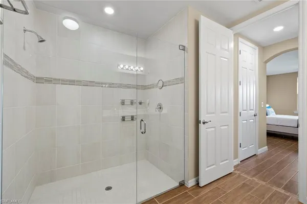 a bathroom with a shower and a glass door