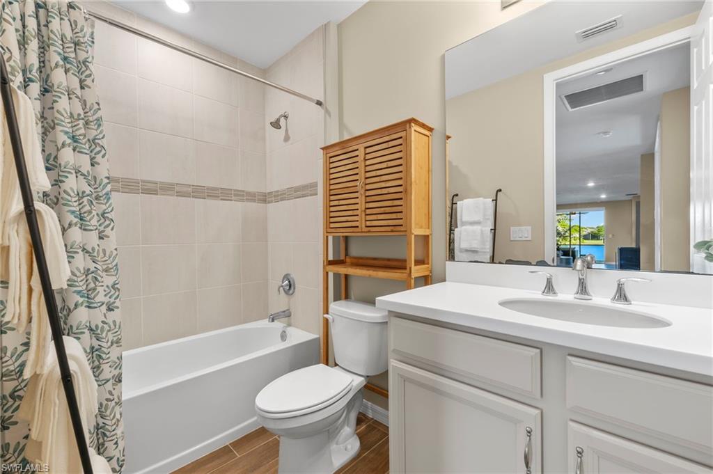 14644 Edgewater Circle Naples, FL 34114 - Photo 20 of 37 a bathroom with a sink toilet and shower