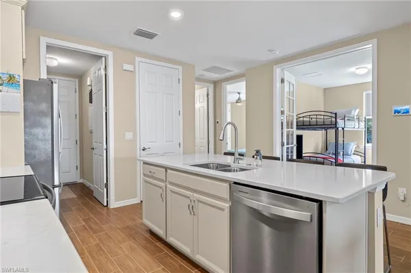 a kitchen with sink stove and refrigerator