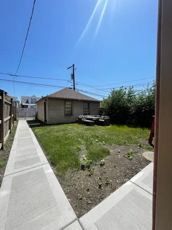 a view of a house with a backyard