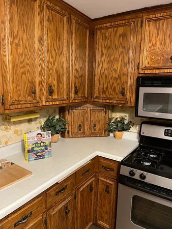 a kitchen with stainless steel appliances granite countertop a refrigerator and a stove
