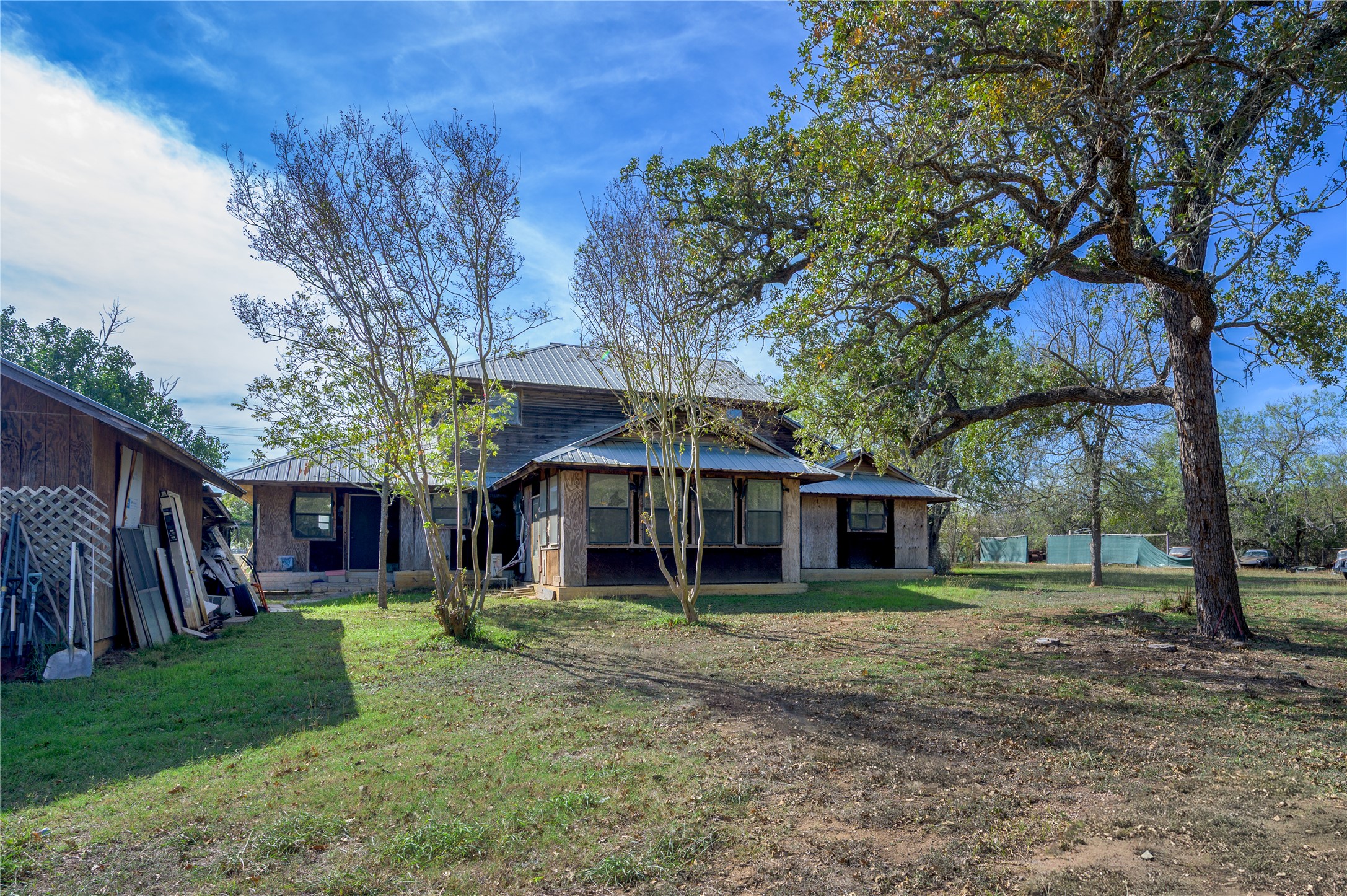 368 Lytton Lane Dale, TX 78616 - Photo 26 of 29 Back of house featuring a metal roof and a yard