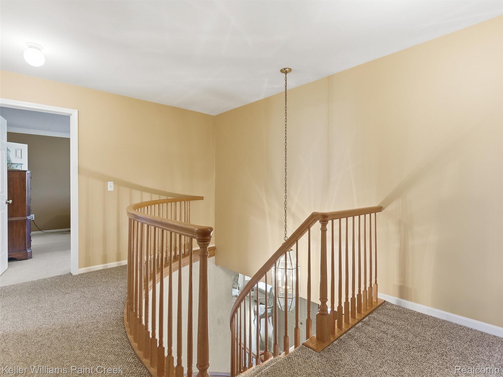 2842 Manorwood Road Troy, MI 48085 - Photo 57 of 72 Curved wooden staircase railing with coordinating balusters