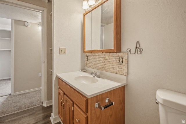 337 North Main Street Central Valley, UT 84754 - Photo 34 of 40 Bathroom with a textured wall, backsplash, vanity, and dark wood-type flooring