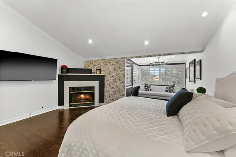 a bedroom with a bed and a fireplace