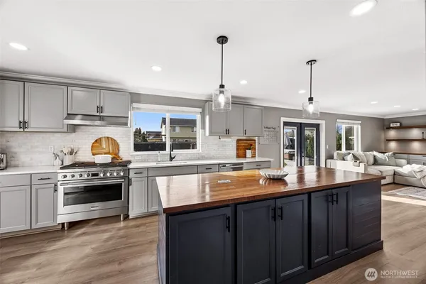 a kitchen with granite countertop a sink and cabinets