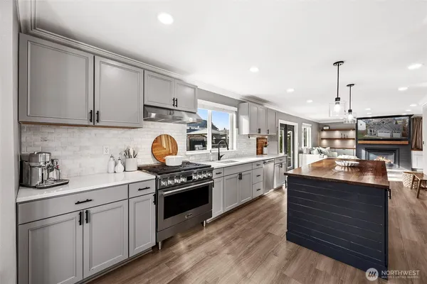 a kitchen with stainless steel appliances granite countertop a stove and a sink