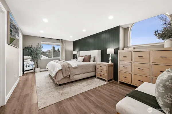 a bedroom with a large bed and a view of living room