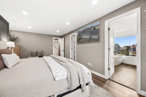 a bedroom with a bed and a mirror