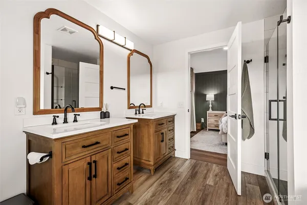 a bathroom with a sink a mirror and shower