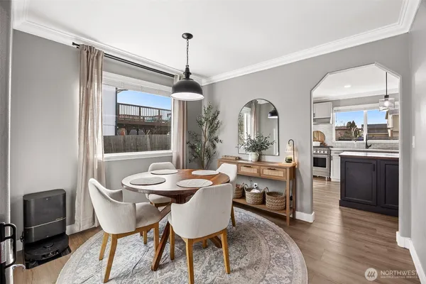 a dining room with furniture a chandelier and window