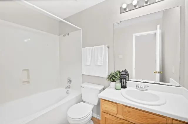 a bathroom with a sink toilet and mirror