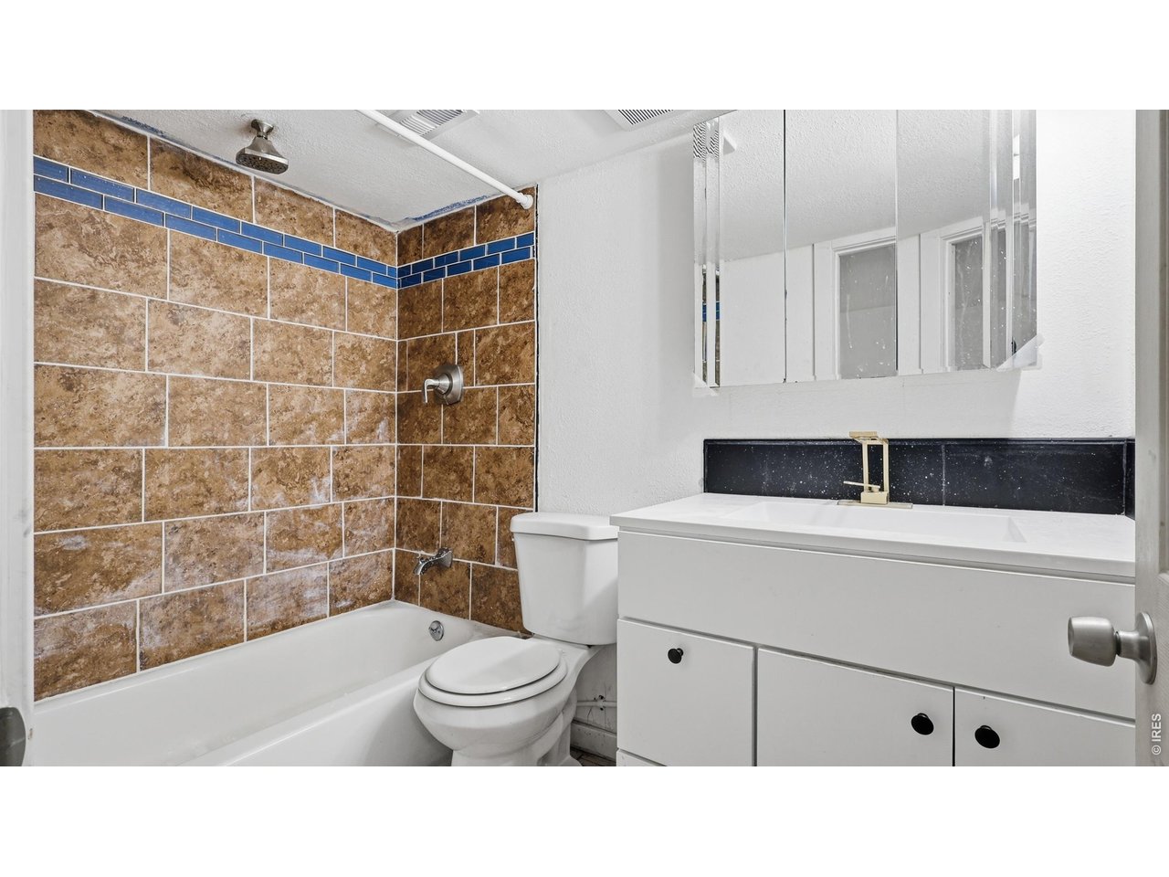 801 Deuel Street Fort Morgan, CO 80701 - Photo 19 of 29 a bathroom with a sink a toilet and shower
