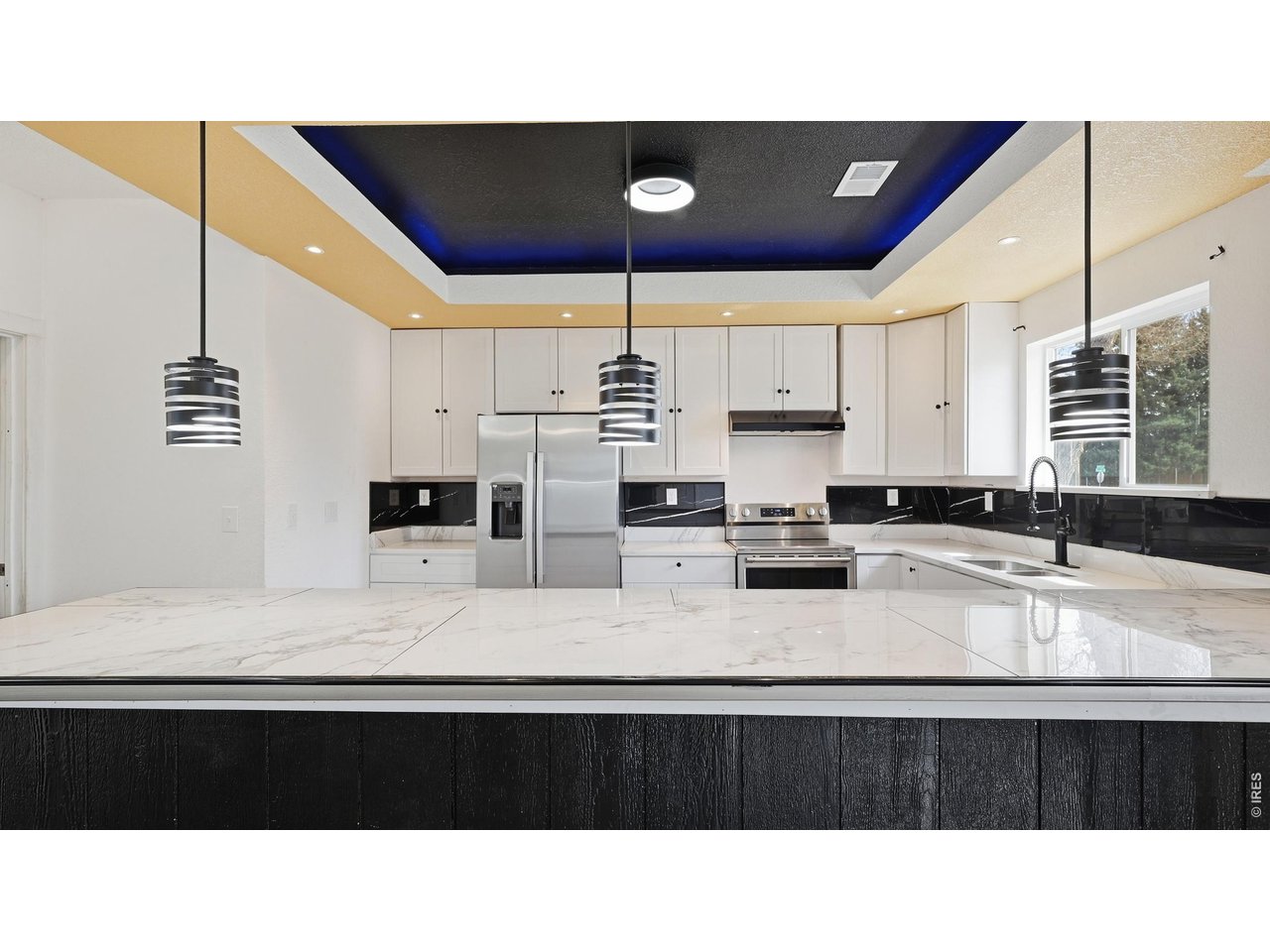 801 Deuel Street Fort Morgan, CO 80701 - Photo 2 of 29 a kitchen with a refrigerator a sink and cabinets
