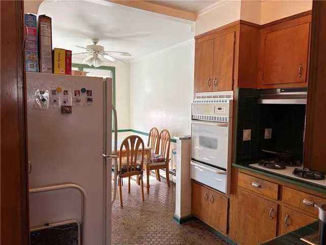 a kitchen with stainless steel appliances granite countertop a refrigerator and microwave