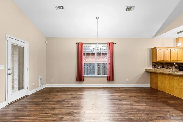 a view of a kitchen with a stove cabinets and wooden floor