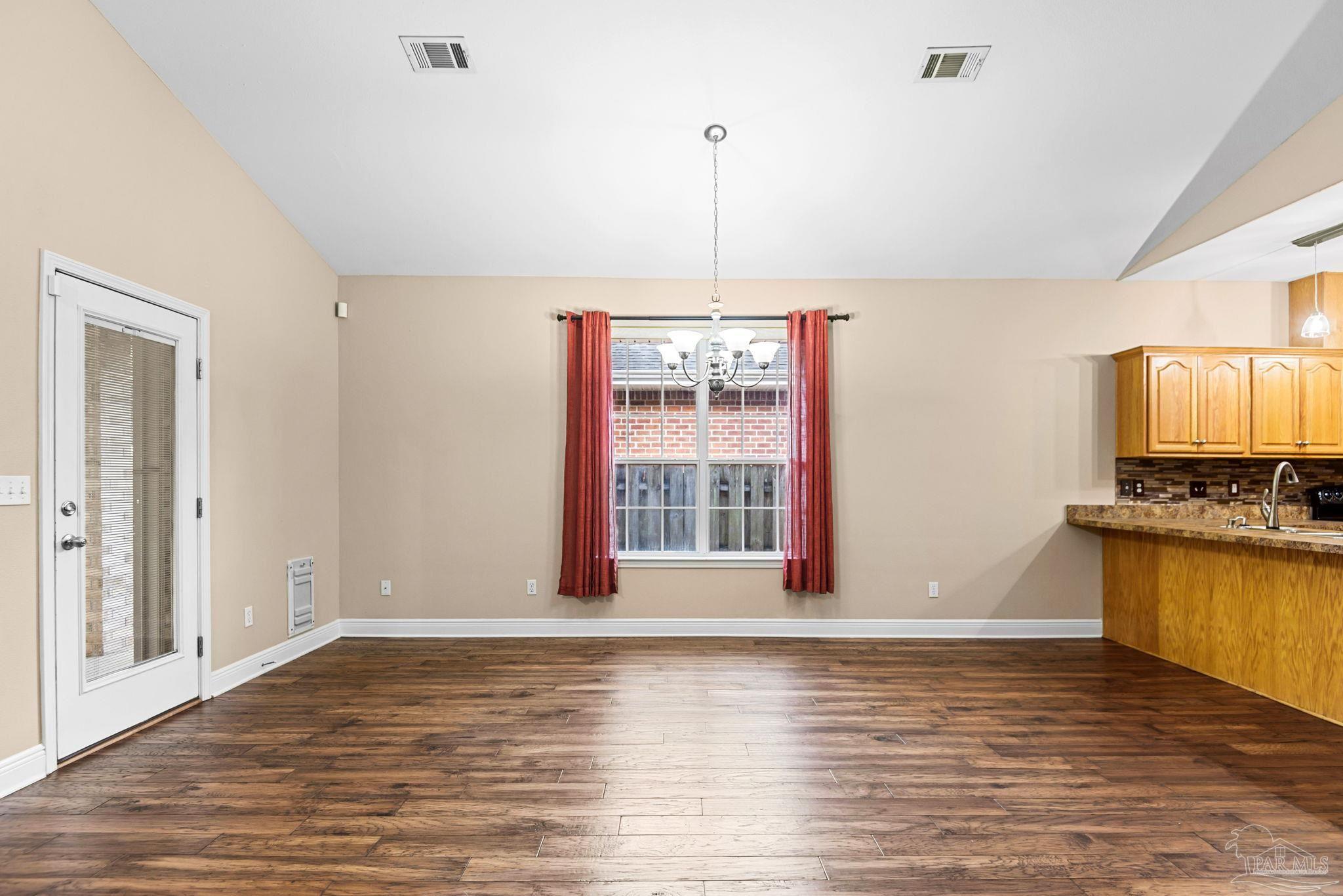 1007 Patriot Place Pensacola, FL 32534 - Photo 13 of 40 a view of a kitchen with a stove cabinets and wooden floor