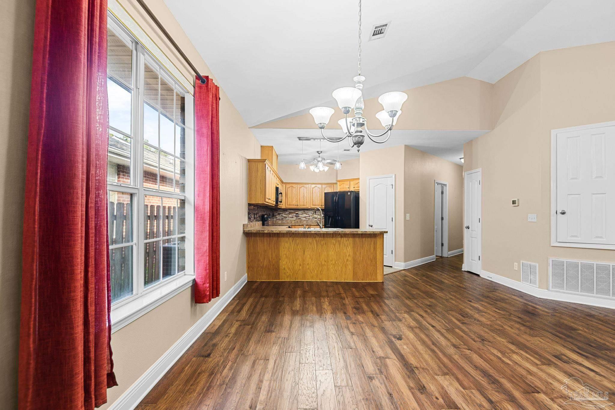 1007 Patriot Place Pensacola, FL 32534 - Photo 14 of 40 a view of a kitchen with kitchen island wooden floor and stainless steel appliances