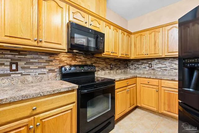 a kitchen with granite countertop cabinets stainless steel appliances and a counter space