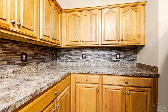 a kitchen with granite countertop a sink and cabinets