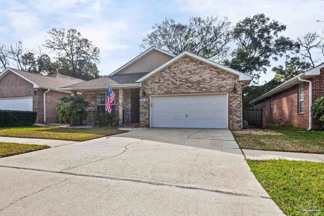 a view of a house with a yard and garage
